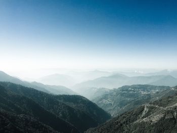 Scenic view of mountains against blue sky