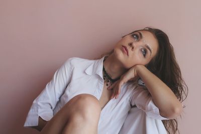 Beautiful young woman lying on bed at home