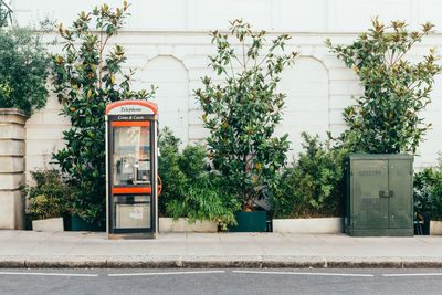 View of telephone booth on sidewalk