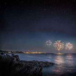 Scenic view of sea against sky at night