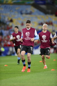 Full length of man running on soccer field