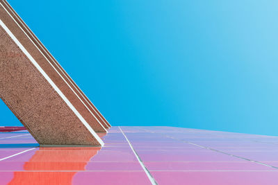 Low angle view of basketball hoop against clear blue sky