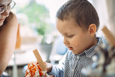 Close-up of girl eating food at home