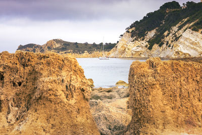 Scenic view of sea and mountains against sky