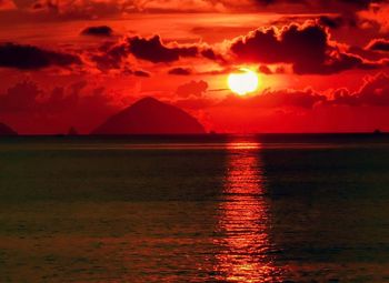 Scenic view of sea against romantic sky at sunset