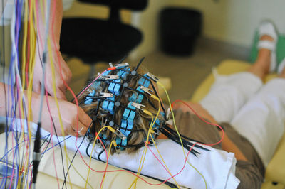 Doctor adjusting equipment on head of patient at hospital