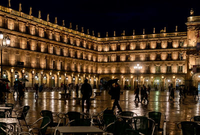 Group of people in illuminated building at night