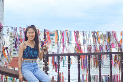 Portrait of smiling young woman standing outdoors