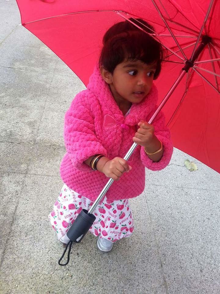 PORTRAIT OF GIRL PLAYING WITH PINK PETALS