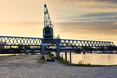 Old abandoned dock crane at the river