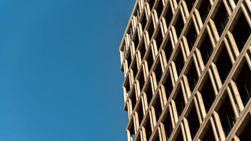 Low angle view of building against clear blue sky