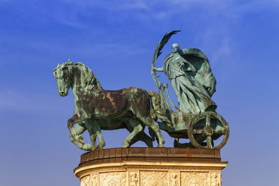 Statue representing peace on a colonnade in heroes square or hosok tere, budapest, hungary.