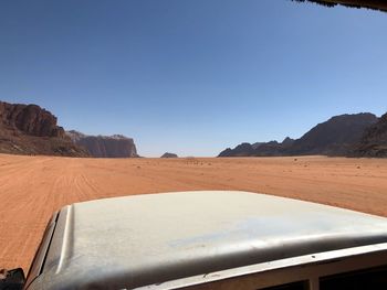 Scenic view of desert against clear blue sky