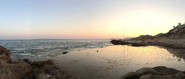 Scenic view of sea against clear sky at sunset