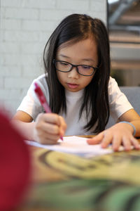 Cute girl studying at table