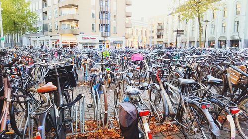 Bicycles parked on street against buildings in city
