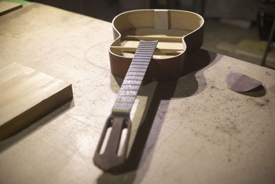 Acoustic guitar repair. guitar without body. details of wood workshop. 