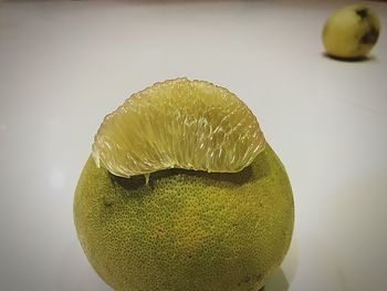 Close-up of lemon slice over white background