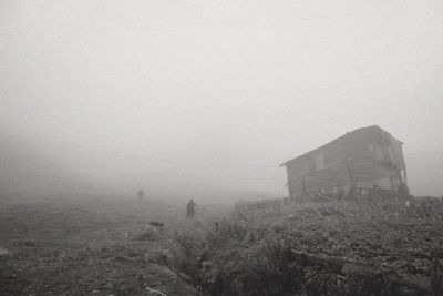 Scenic view of foggy weather against sky