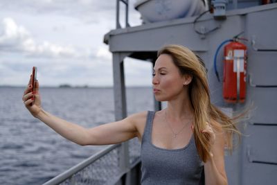 Beautiful white woman make selfie on a ferry boat 