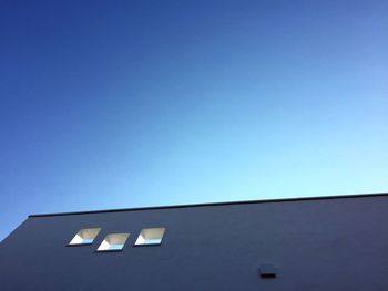 Low angle view of built structure against clear blue sky