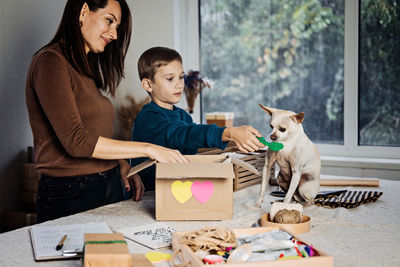 Charity care pet box, donation box, gift package for pet shelter. happy family, mother, kid and dog