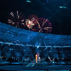 Low angle view of fireworks against sky at night