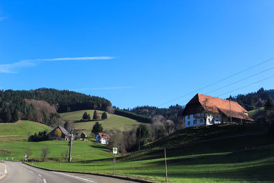 View of soccer field against clear blue sky