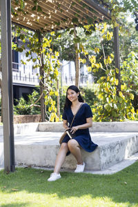 Young woman sitting in yard