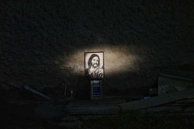 Low angle view of illuminated text on wall of building