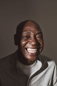 Senior man laughing over white background