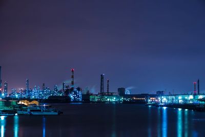 River with illuminated built structures in distance