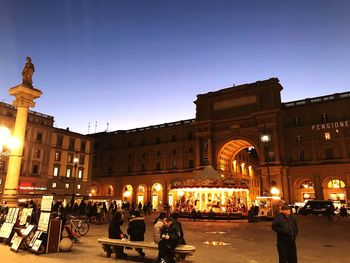 Group of people in front of building at night