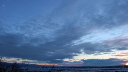 Scenic view of sea against storm clouds