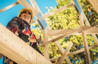 Low angle view of man working at construction site