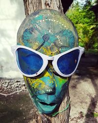 Close-up of sunglasses against sky