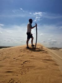 Full length of man standing on desert against sky