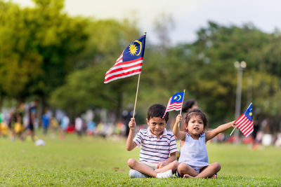 Boy and girl playing with flag