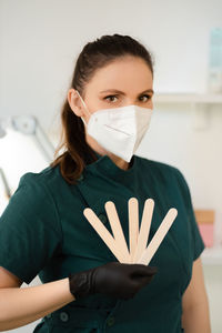 Portrait of young woman wearing surgical mask