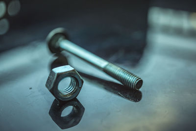 Close-up of nut and bolt on table