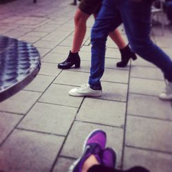 Low section of woman standing on tiled floor