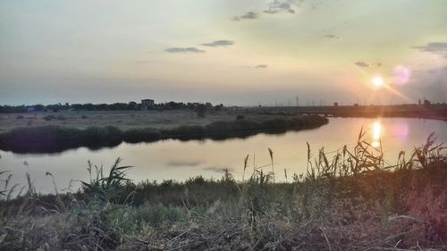 Scenic view of lake against sky during sunset