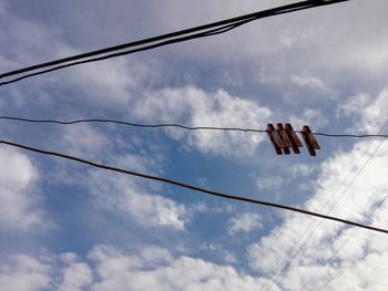 Low angle view of cables against sky