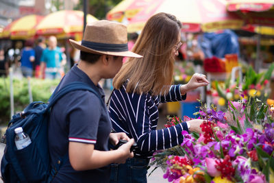 Rear view of people at market stall