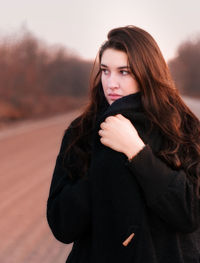 Portrait of beautiful woman standing in winter