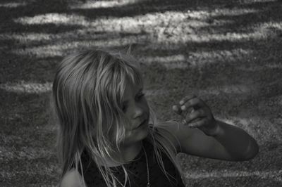 Close-up of girl gesturing on field