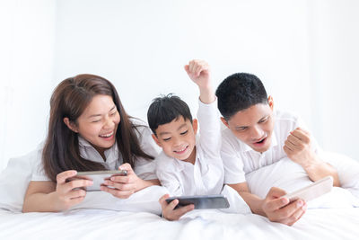 Group of people on bed at home