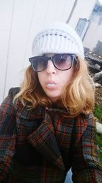 Portrait of young woman in sunglasses during winter