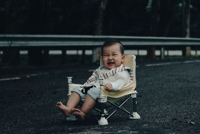 Full length of a baby girl sitting outdoors