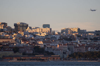 Buildings in city against clear sky